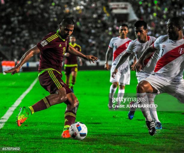 Venezuela's forward Salomon Rondon vies for the ball with Peru's defender Alberto Rodriguez during their 2018 FIFA World Cup qualifier football match...
