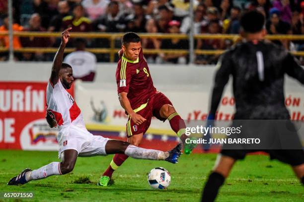 Peru's defender Christian Ramos vies for the ball with Venezuela's midfielder Darwin Machis during their 2018 FIFA World Cup qualifier football match...