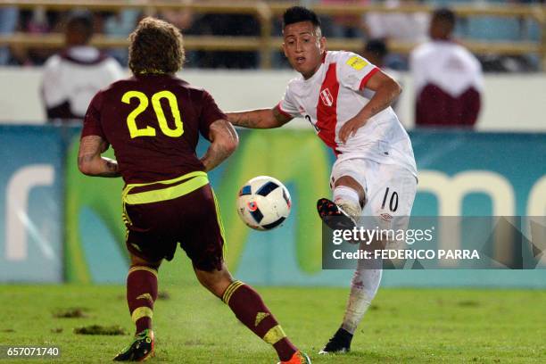Peru's forward Christian Cueva vies for the ball with Venezuela's defender Rolf Feltscher during their 2018 FIFA World Cup qualifier football match...