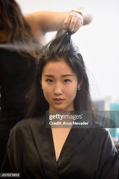 Model gets ready backstage during day four of Vancouver Fashion Week Fall/Winter 2017 at Chinese Cultural Centre of Greater Vancouver on March 23,...