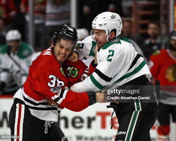 Ryan Hartman of the Chicago Blackhawks and Dan Hamhuis of the Dallas Stars fight in the second period at the United Center on March 23, 2017 in...