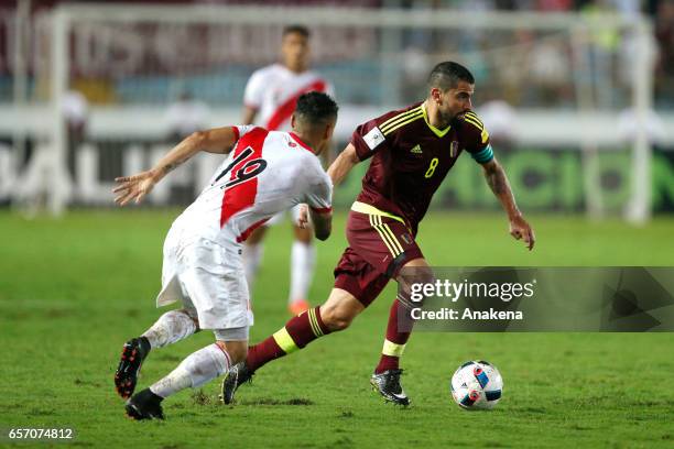 Tomas Rincon of Venezuela drives the ball past Yoshimar Yotun of Peru during a match between Venezuela and Peru as part of FIFA 2018 World Cup...