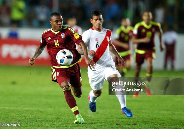Jhon Murillo of Venezuela and Miguel Trauco of Peru run for the ball during a match between Venezuela and Peru as part of FIFA 2018 World Cup...