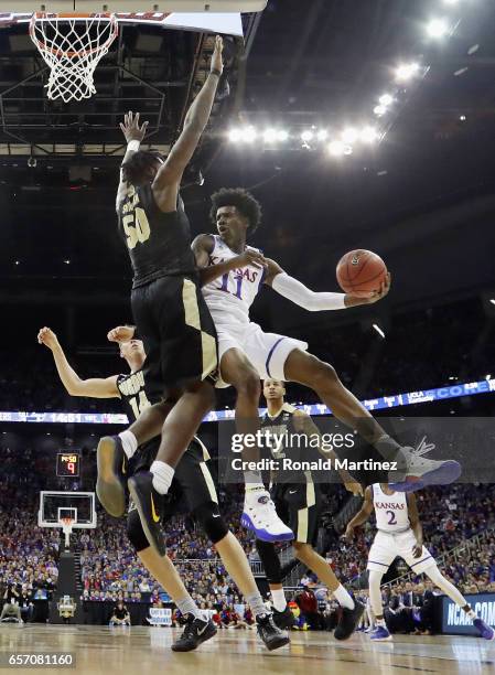 Josh Jackson of the Kansas Jayhawks handles the ball against Caleb Swanigan of the Purdue Boilermakers in the first half during the 2017 NCAA Men's...