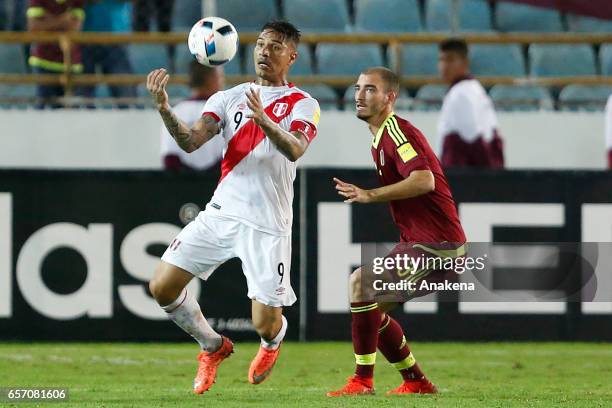 Paolo Guerrero of Peru controls the ball as Mikel Villanueva of Venezuela defends during a match between Venezuela and Peru as part of FIFA 2018...