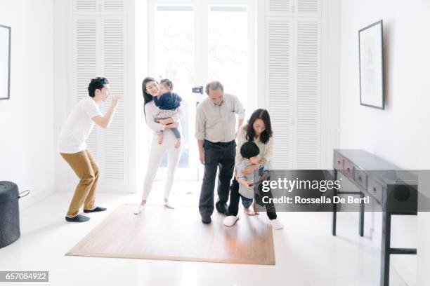 young family welcoming grandparents at home - baby arrival stock pictures, royalty-free photos & images