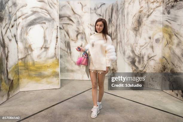 Visitor poses in front of artist Taroko Gorge's Cai Guo-Qiang, 2009' during Art Basel Hong Kong 2017 at Hong Kong Convention and Exhibition Centre on...