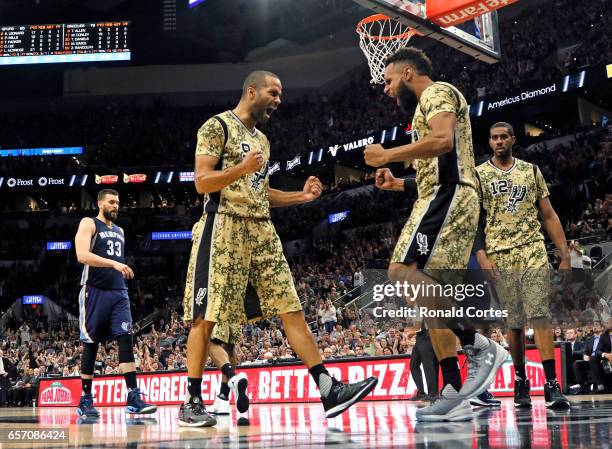 Tony Parker of the San Antonio Spurs and Patty Mills of the San Antonio Spurs celebrate after a Mills basket against the Memphis Grizzlies at AT&T...