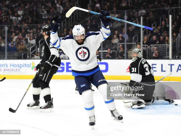 Mathieu Perreault of the Winnipeg Jets celebrates his goal in front of Ben Bishop and Derek Forbort of the Los Angeles Kings to take a 1-0 lead over...