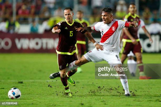 Alejandro Guerra of Venezuela fights for the ball with Paolo Guerrero of Peru during a match between Venezuela and Peru as part of FIFA 2018 World...