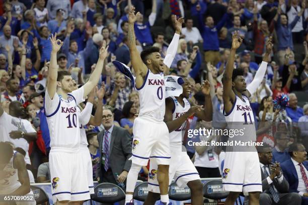 Sviatoslav Mykhailiuk, Frank Mason III, Dwight Coleby and Josh Jackson of the Kansas Jayhawks celebrate defeating the Purdue Boilermakers 98-66...