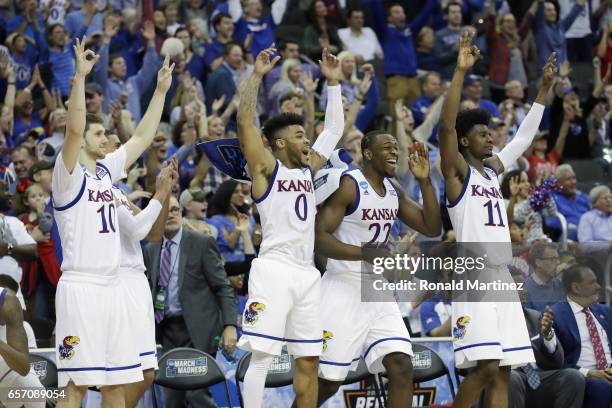 Sviatoslav Mykhailiuk, Frank Mason III, Dwight Coleby and Josh Jackson of the Kansas Jayhawks celebrate defeating the Purdue Boilermakers 98-66...