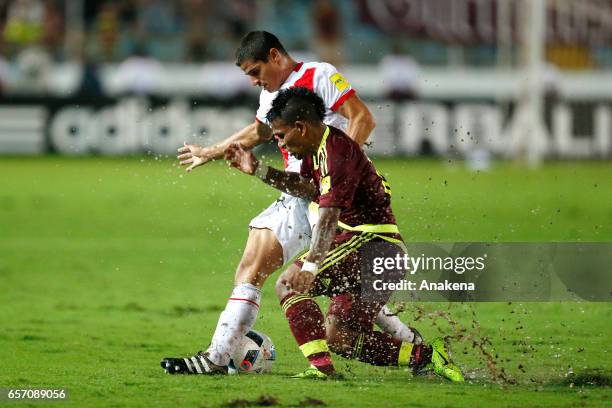 Romulo Otero of Venezuela and Aldo Corzo of Peru fight for the ball during a match between Venezuela and Peru as part of FIFA 2018 World Cup...