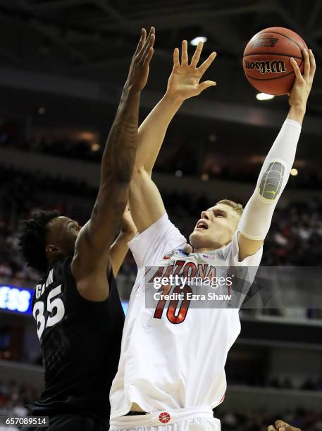 Lauri Markkanen of the Arizona Wildcats goes up against RaShid Gaston of the Xavier Musketeers in the first half during the 2017 NCAA Men's...