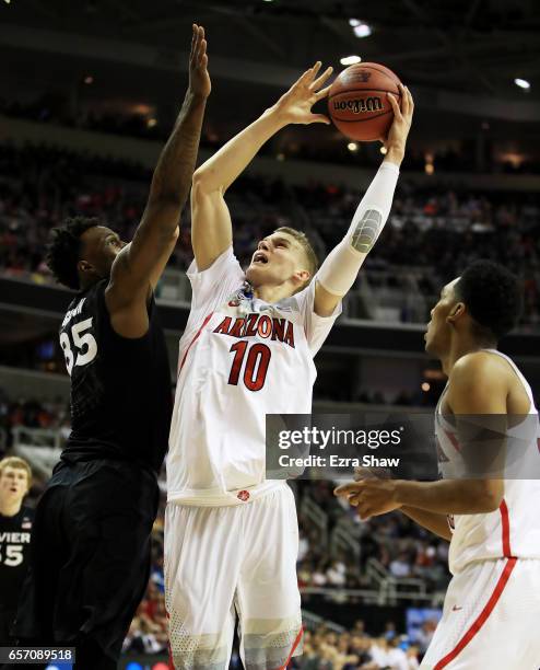 Lauri Markkanen of the Arizona Wildcats goes up against RaShid Gaston of the Xavier Musketeers in the first half during the 2017 NCAA Men's...