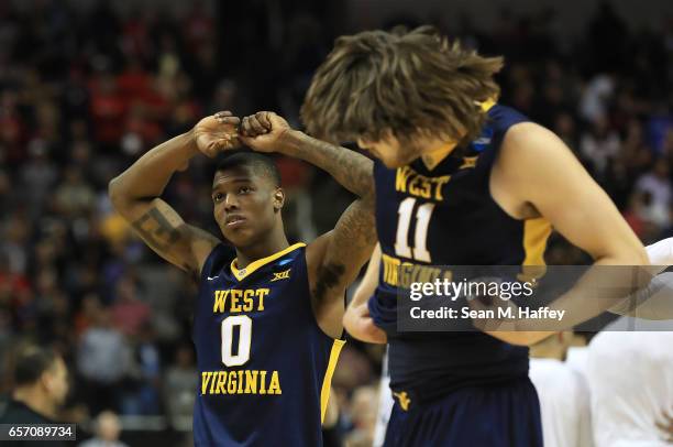 Teyvon Myers and Nathan Adrian of the West Virginia Mountaineers react after their loss to the Gonzaga Bulldogs during the 2017 NCAA Men's Basketball...