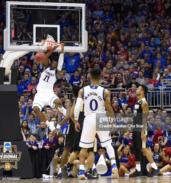 S Josh Jackson dunks as Jayhawks guard Frank Mason III and Purdue's Vince Edwards watch in the second half in the Sweet Sixteen round of the NCAA...