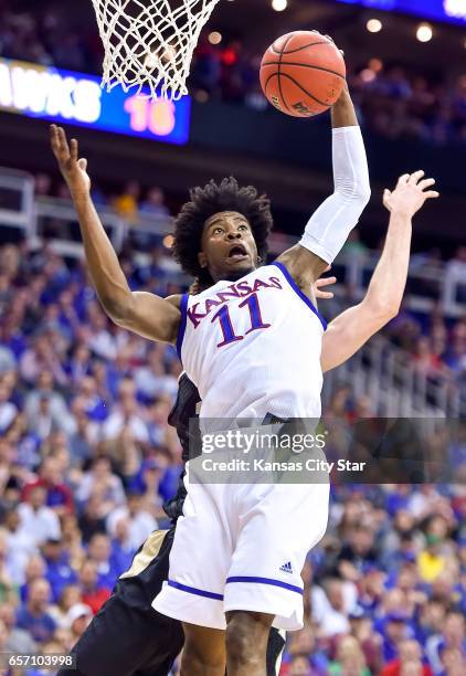 Kansas guard Josh Jackson pulls down a rebound against Purdue in the Sweet Sixteen round of the NCAA Tournament at Sprint Center in Kansas City, Mo.,...