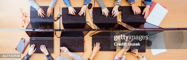 girls in computer lab coding on laptops - kid e learning stock pictures, royalty-free photos & images