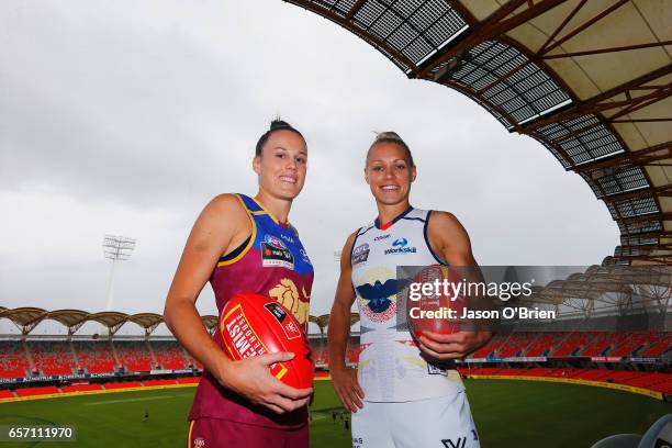 Erin Phillips of the Crows and Emma Zielke of the Lions pose for a photo during the Women's AFL Grand Final press conference at Metricon Stasium on...