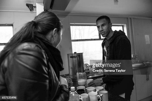 Isaac Hayden of Newcastle United makes coffee during a visit to th e Benwell Lane Foodbank on March 21, 2017 in Newcastle upon Tyne, England.