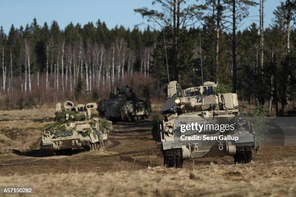 Army M2A3 Bradley fighting vehicles of Chaos Company, 1-68 Armor Battalion of the 3rd Brigade Combat Team, 4th Infantry Division, attack an enemy...