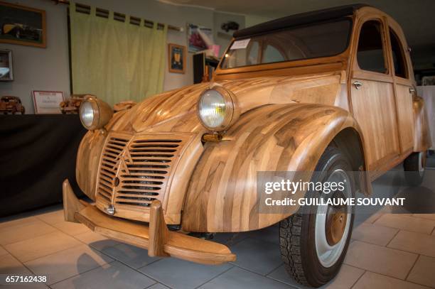 Details of a handbuilt wooden 2CV Citroen Car built as an exact one/one replica are pictured on March 20 near Loches, Central France. A retired...