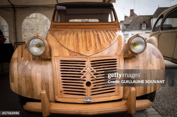 Details of a handbuilt wooden 2CV Citroen Car built as an exact one/one replica are pictured on March 20 near Loches, Central France. A retired...