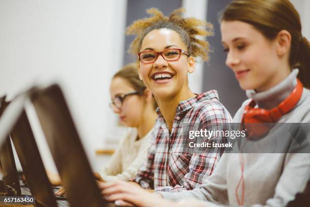 afro american woman in computer programming class and smiling - happy software developer stock pictures, royalty-free photos & images