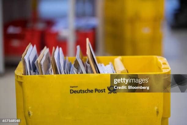 Letters sit in a tray ahead of distribution inside a Deutsche Post AG delivery station in Hamburg, Germany, on Tuesday, March 7, 2017. With car...