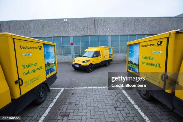 Three StreetScooter emission-free electric light commercial vehicles sit in the parking lot at a Deutsche Post AG delivery station in Hamburg,...