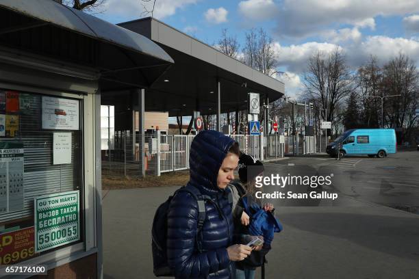 Two young women who had just crossed from Russia into Estonia walk past the border control and a kiosk on March 23, 2017 in Narva, Estonia. Estonia...