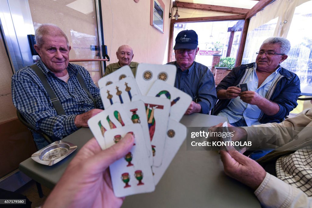 The group old man playing cards out bar in Acciaroli,...