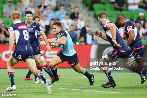 Bernard Foley of the Waratahs runs with the ball on his way to score the winning try during the round five Super Rugby match between the Rebels and...