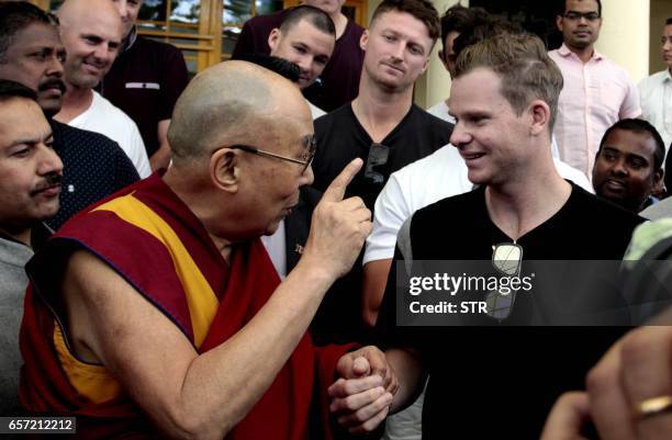 Tibetan Spiritual Leader The Dalai Lama gestures as he speaks with Australian touring cricket captain Steve Smith at his residence in Dharamsala on...