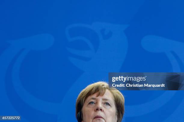 German Chancellor Angela Merkel reacts while speaking to the media with Palestinian President Mahmoud Abbas ahead of their meeting at the Chancellory...