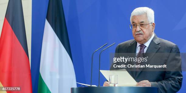 Palestinian President Mahmoud Abbas reacts while speaking to the media with German Chancellor Angela Merkel ahead of a common meeting at the...