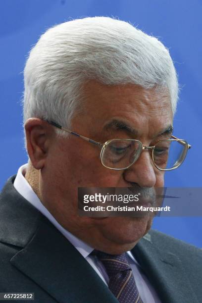 Palestinian President Mahmoud Abbas reacts while speaking to the media with German Chancellor Angela Merkel ahead of a common meeting at the...