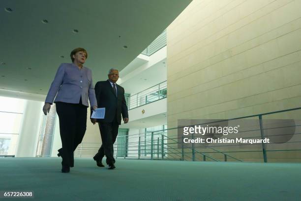 German Chancellor Angela Merkel and Palestinian President Mahmoud Abbas arrive to point a statement ahead of a common meeting at the Chancellory on...