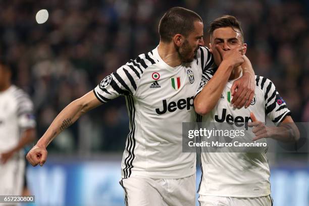 Paulo Dybala of Juventus celebrates the opening goal with team mate Leonardo Bonucci during the UEFA Champions League Round of 16 second leg match...