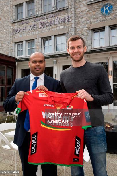 Oostende's new player Nicolas Lombaerts and his manager Santosh Verhulst poses with his new jersey after a press conference in Durbuy on March 24,...