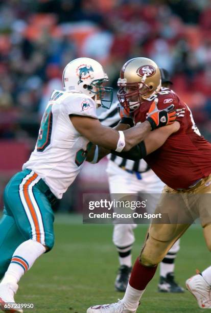 Jason Taylor of the Miami Dolphins rushes up against Kyle Kosler of the San Francisco 49ers during an NFL football game November 28, 2004 at...