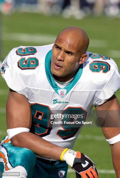 Jason Taylor of the Miami Dolphins looks on against the Denver Broncos during an NFL football game December 12, 2004 at Mile High Stadium in Denver,...