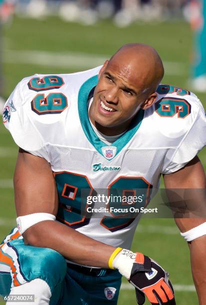 Jason Taylor of the Miami Dolphins looks on against the Denver Broncos during an NFL football game December 12, 2004 at Mile High Stadium in Denver,...