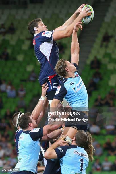 Ned Hanigan of the Waratahs tries to intercept Calum Retallick of the Rebels during the round five Super Rugby match between the Rebels and the...