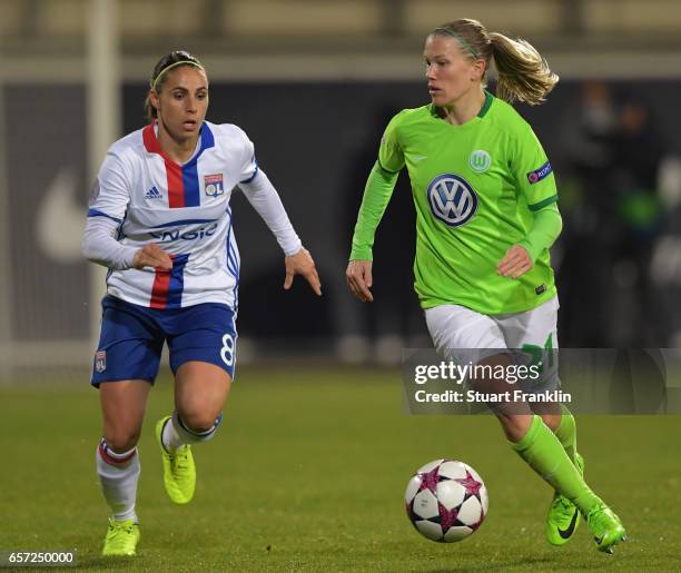 Lara Dickenmann of Wolfsburg is challenged by Jessica Houara-D'Hommeaux of Lyon during the UEFA Women's Champions League Quater Final first leg match...