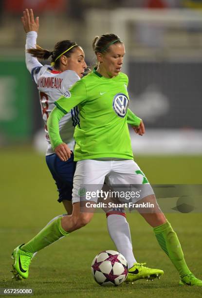 Lara Dickenmann of Wolfsburg is challenged by Jessica Houara-D'Hommeaux of Lyon during the UEFA Women's Champions League Quater Final first leg match...