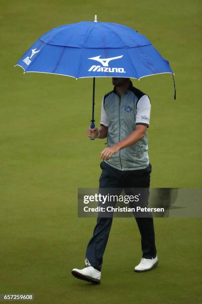 Chris Wood of England walks while rain falls on the 2nd hole of his match during round three of the World Golf Championships-Dell Technologies Match...