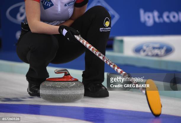 Emma Miskew of Canada waits above a stone during their match against Russia at the Women's Curling World Championships in Beijing on March 24, 2017....