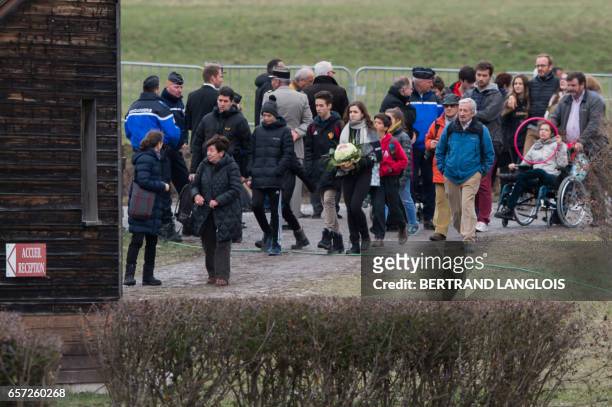Relatives and friends of victims leave the commemoration ceremonies at the Vernet memorial, southeastern France, on March 24, 2017 to mark the second...